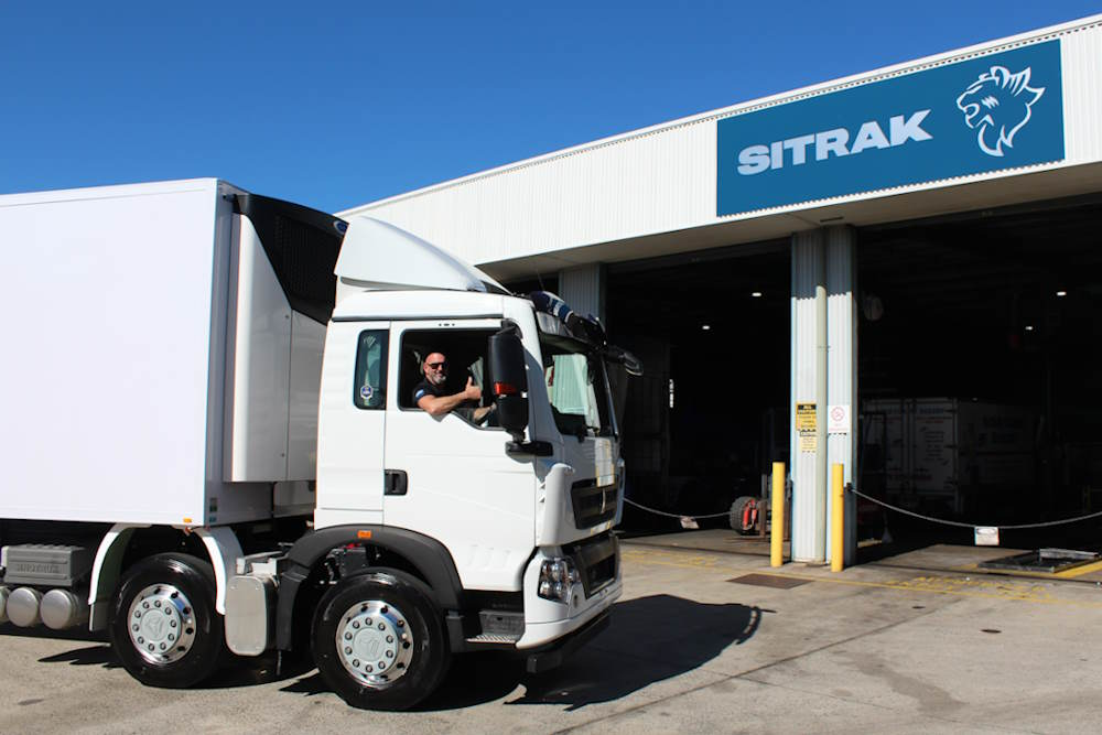 Sitrak truck with driver giving thumbs up